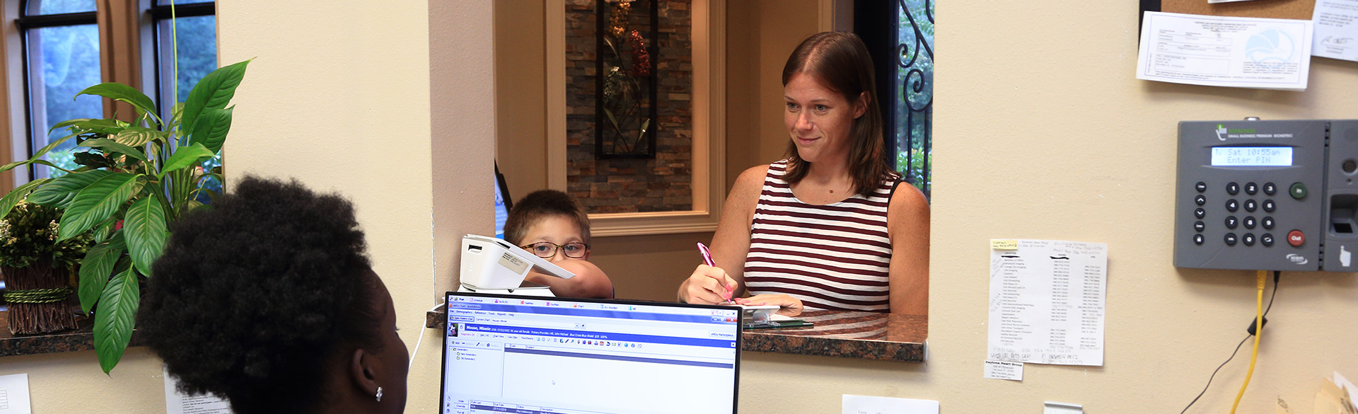 woman with a child checking in to an appointment