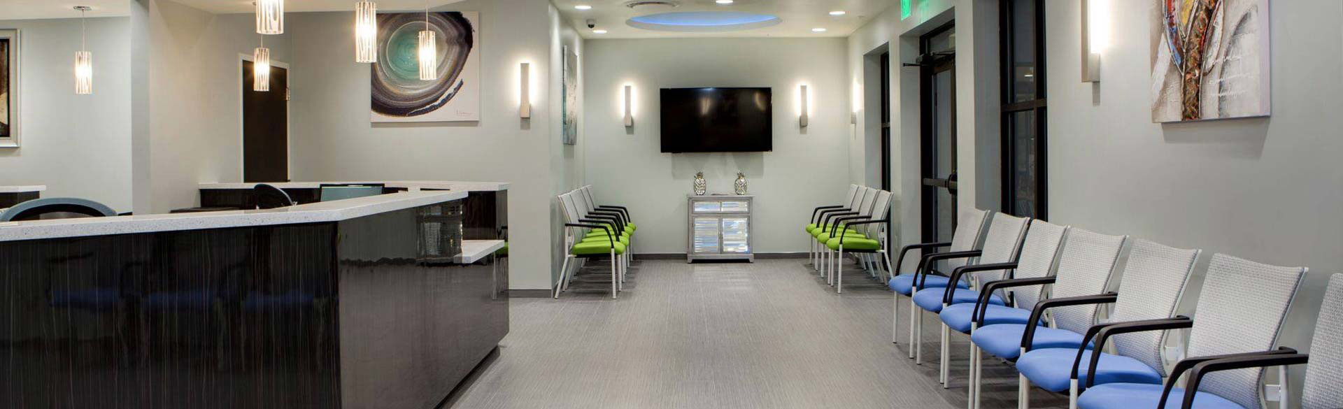 office waiting area with blue and green chairs